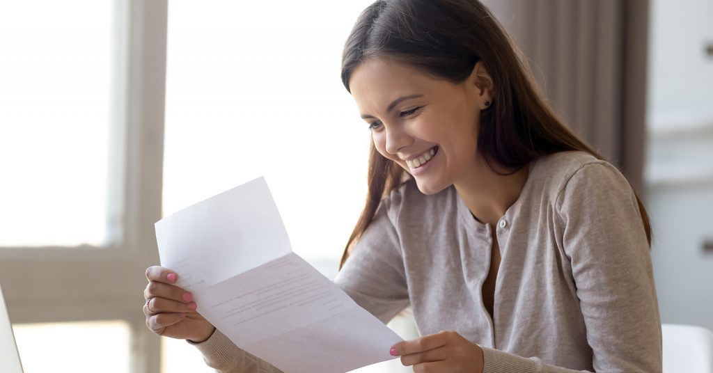Student happy looking at letter