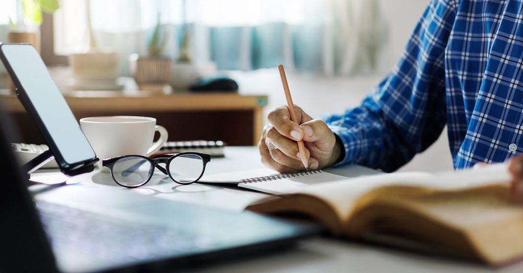 Person reading a notepad and studying