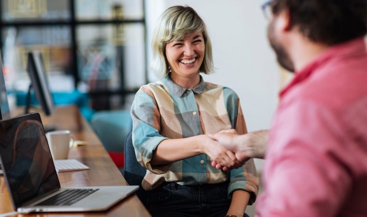 Woman shaking hands with a colleague