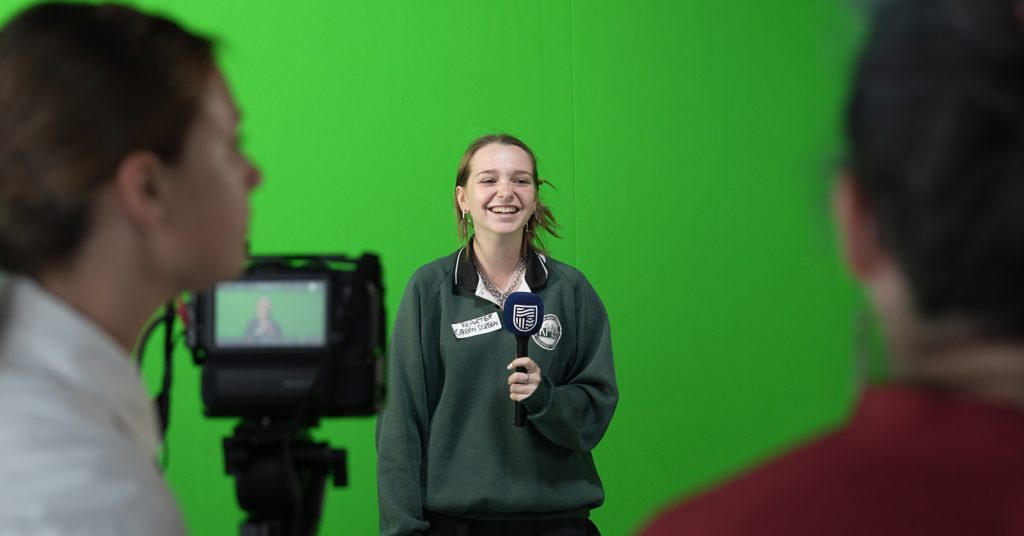 A school student reads off a teleprompter at the comms precinct on Charles Sturt's Bathurst campus