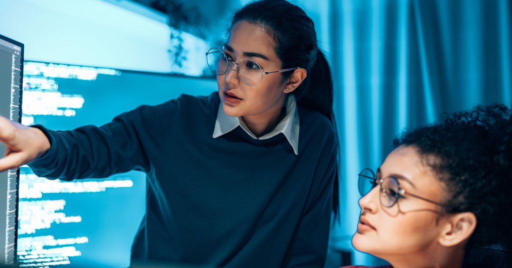 woman pointing at monitor