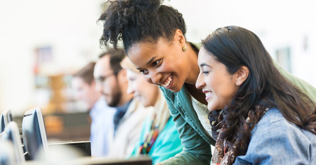 two women looking at laptop