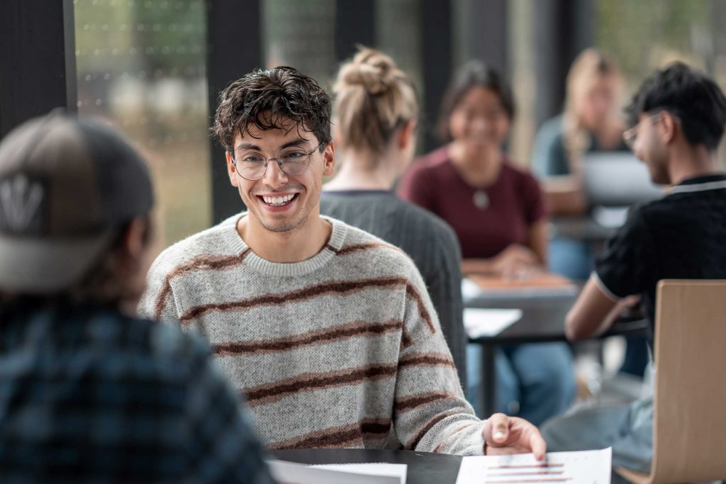 Students talking at desk