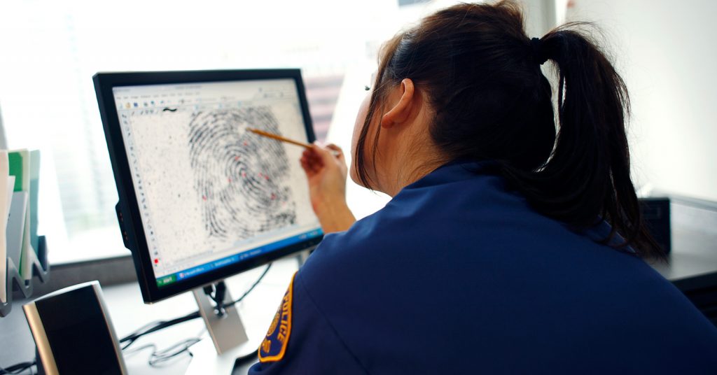 woman looking a fingerprint on screen