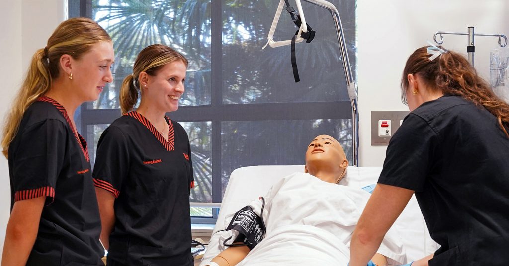 student nurses around bed